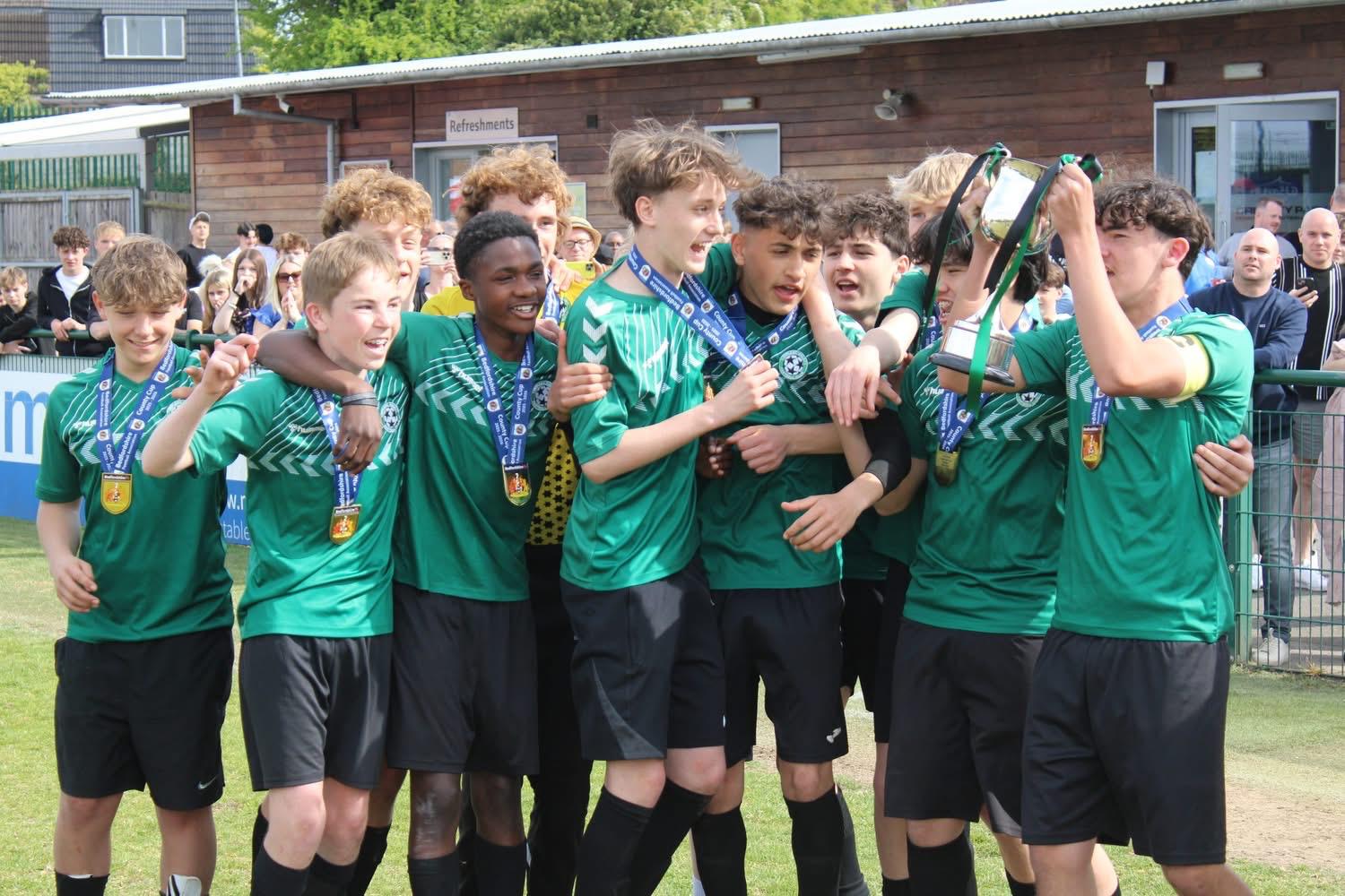 Linslade Galaxy players celebrating with a cup and medals