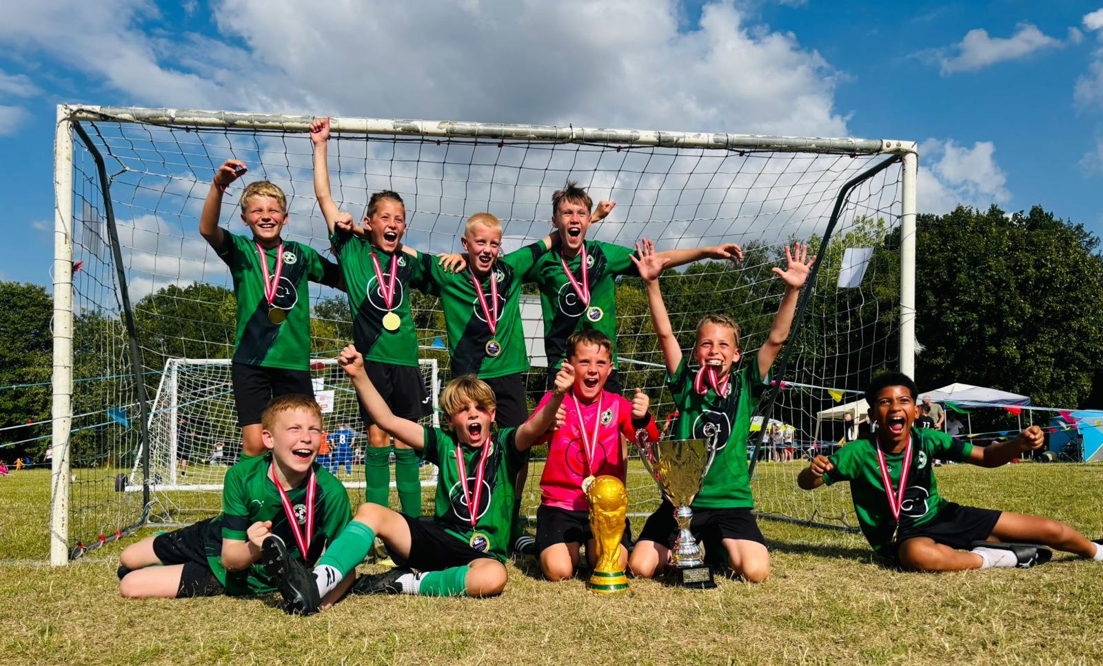 Linslade Galaxy FC players celebrating with medals and trophies